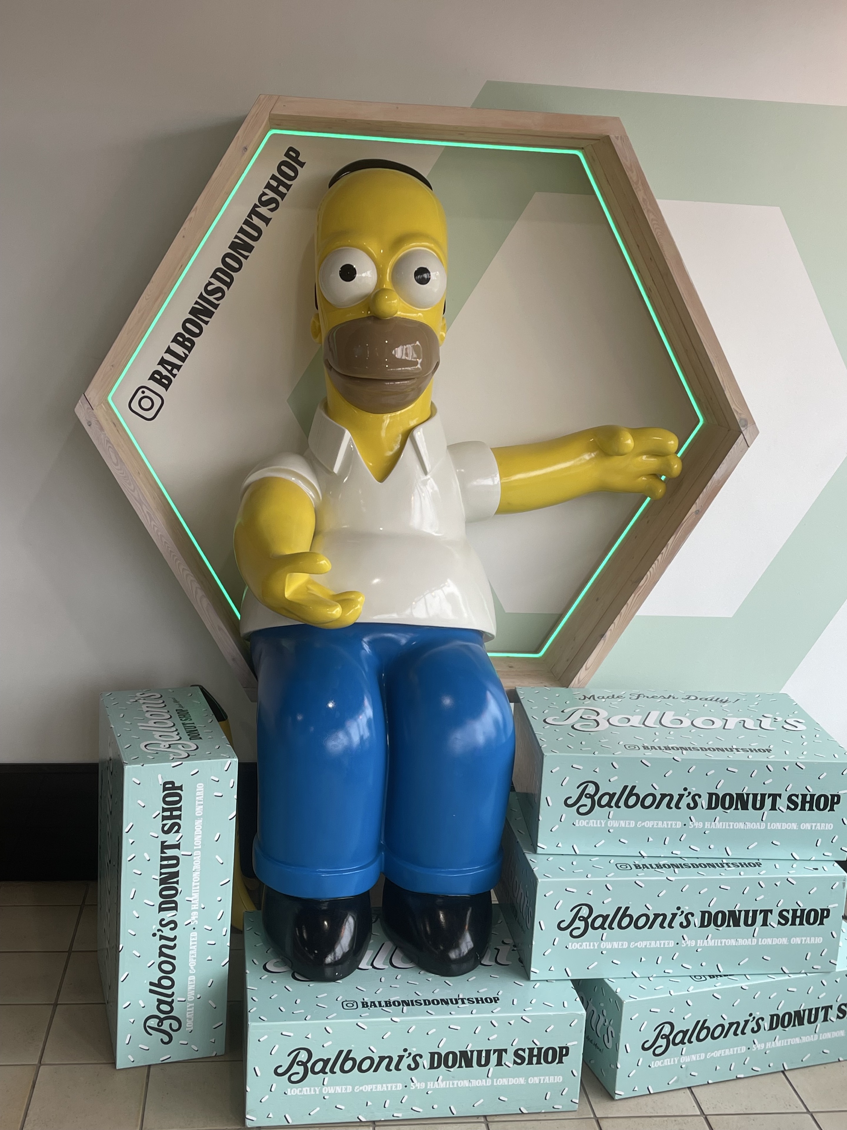 Homer Simpson figure surrounded by Balboni’s Donut Shop boxes inside the Hamilton Road shop